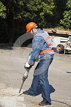 Worker with pneumatic hammer drill equipment