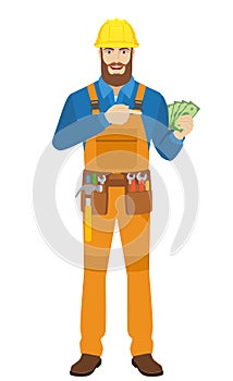 Worker pointing at money in his hand