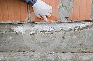 Worker points at waterproofing membrane, protective layer against moisture