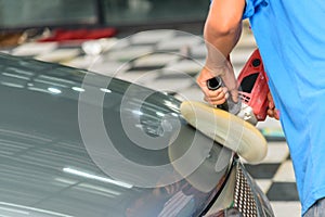 Worker polish the car by Car