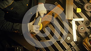 Worker polishing metal with grinder. Interior of a heavy industry factory with a worker using a grinder. Electric grinding of