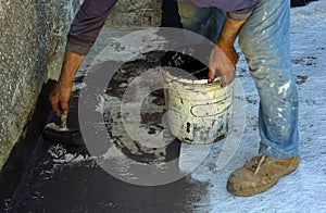 Worker posing with brush bituminous sheath liquid photo