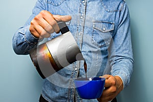 Worker pouring coffee from moka pot