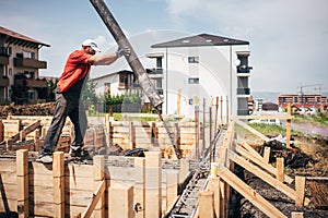 Worker pouring concrete details - concrete pouring during foundation building of house