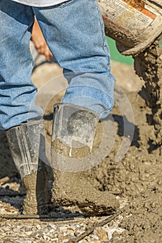 Worker Pouring Concrete Slurry on a Construction Site photo