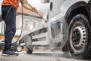 Worker Power Washing His Towing Truck