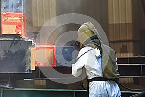Worker preparation surface by sand blasting process photo