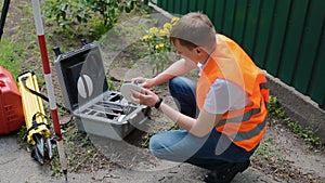 Worker prepare geodetic device for surveying