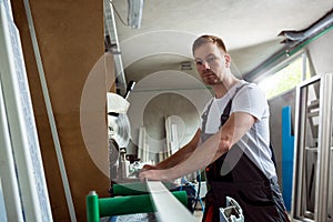 Worker prepares pvc profiles in the workshop