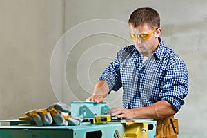Worker prepares the woodworking mashine to work