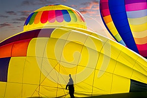 Worker Preparing Hot Air Balloons for Flight