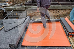 Worker preparing insulation material for basement wall