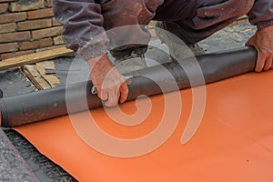 Worker preparing insulation material for basement wall 4