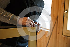 Worker preparing to install new three pane wooden windows