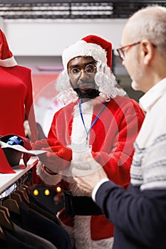 Worker presenting ties to senior man