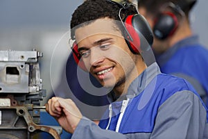 Worker with process machinery in factory