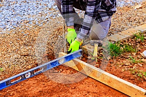 Worker produced with removable timber formwork for concrete pouring on a foundation