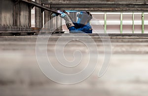 Worker with protective mask welding metal