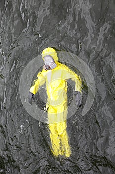 Worker in protective suit in water