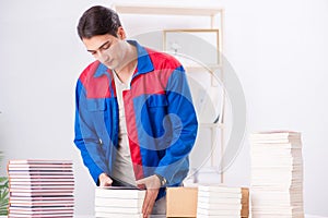 The worker in publishing house preparing book order