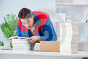 The worker in publishing house preparing book order