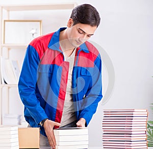 Worker in publishing house preparing book order