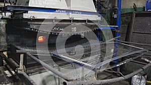 Worker puts the glass sheet on the frame.The production of stalinite.