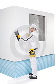 Worker rasping insulation panels