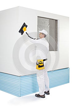 Worker rasping insulation panels