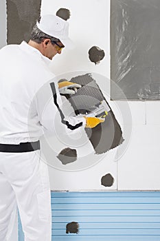 Worker reinforcing a window frame