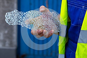 A worker with the remains of a broken toughened glass in his hands