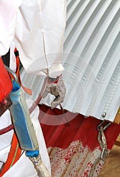 Worker during the remediation of asbestos from the roof