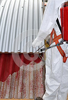 Worker during the remediation of asbestos from the roof