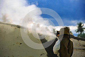 Worker is remove paint by air pressure sand blasting