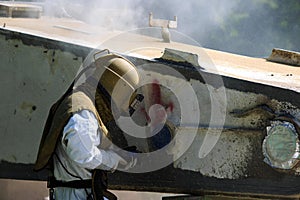 Worker is remove paint by air pressure sand blasting