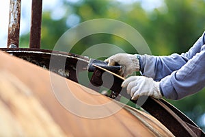 Worker is remove paint by sand paper