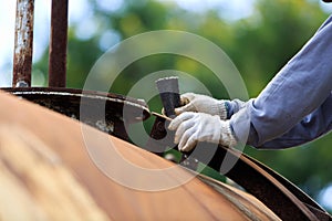 Worker is remove paint by sand paper