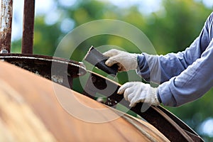 Worker is remove paint by sand paper
