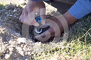 Worker repair lawn sprinkler