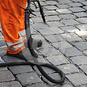 Worker repairing cobblestones
