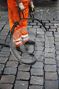Worker repairing stone road