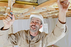 Worker repairing wood ceiling
