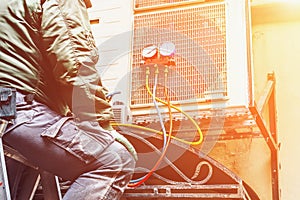 The worker repairs or prevents the air conditioner on the wall, Air Conditioning Repair concept