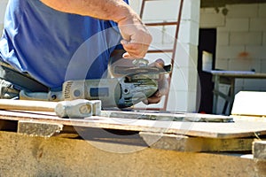 a worker replaces a grinding disc on a grinding machine that is wasted during metal cutting