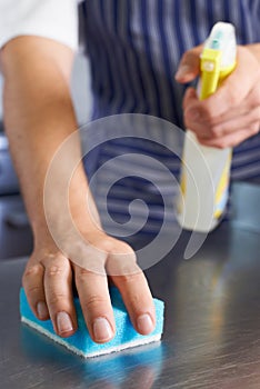 Close Up Of Worker In Restaurant Kitchen Cleaning Down After Service