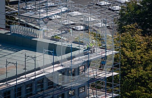 Worker resting alone on top of a construction site.