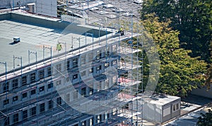 Worker resting alone on top of a construction site.