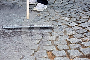 Worker resurfacing cobblestones photo