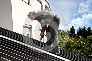 Worker roofer builder working on roof structure