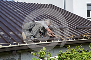 Worker roofer builder working on roof structure